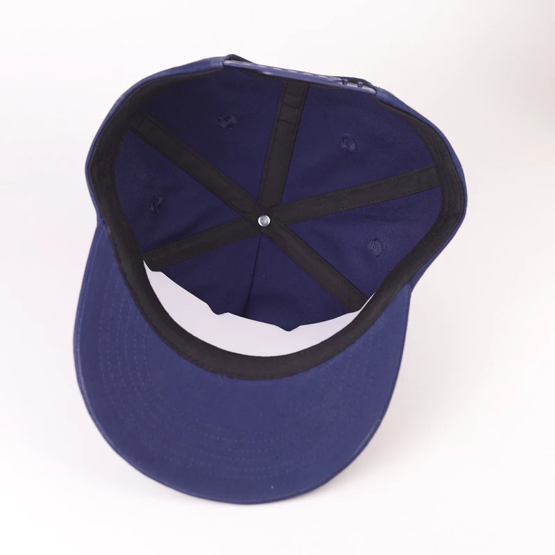 Inside construction of a cotton six-panel cap showing seam tape and sweatband