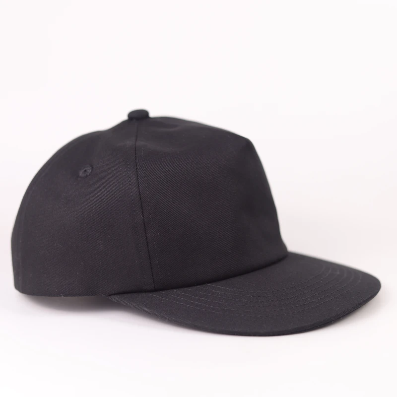 Side profile of a black cotton short-brim six-panel cap