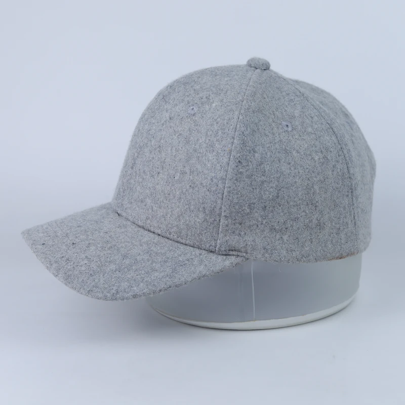 Opposite side of the grey felt-look blank cap showing crown seams and visor profile