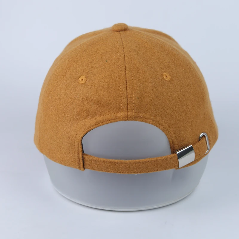 Rear of the tan suede-look cap showing fabric strap and metal adjustment hardware