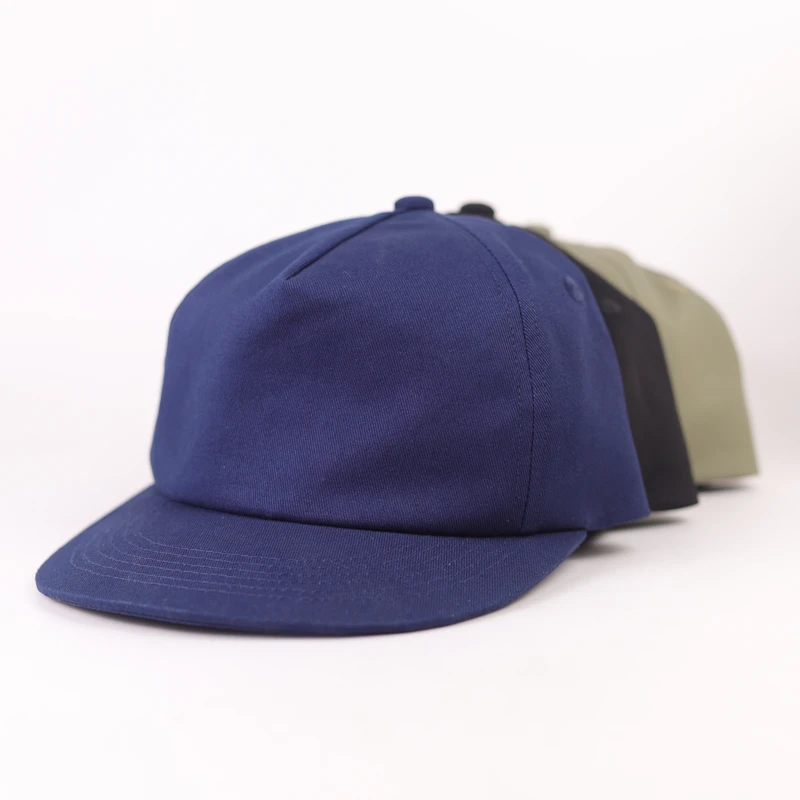 Blue, black and khaki compact-brim caps arranged as separate color references