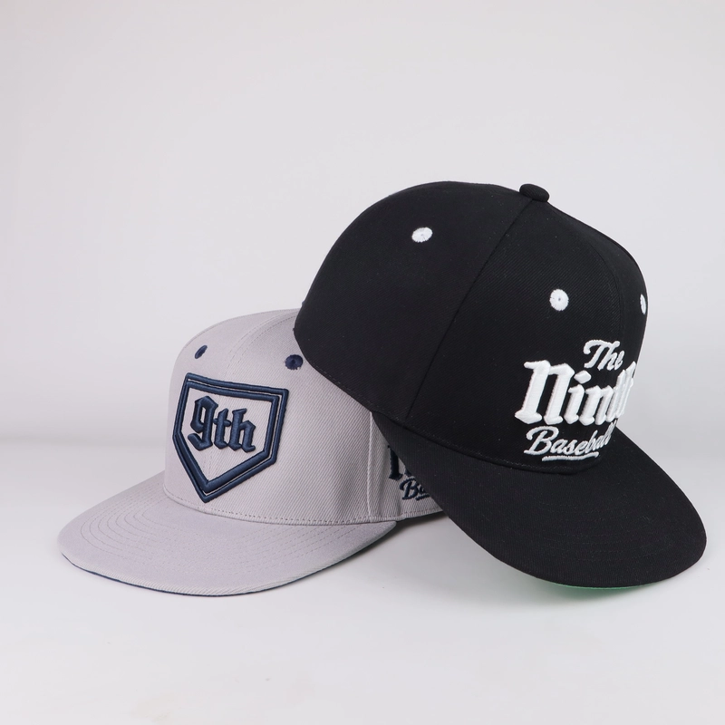 Light grey and black embroidered flat-brim caps viewed from the front side