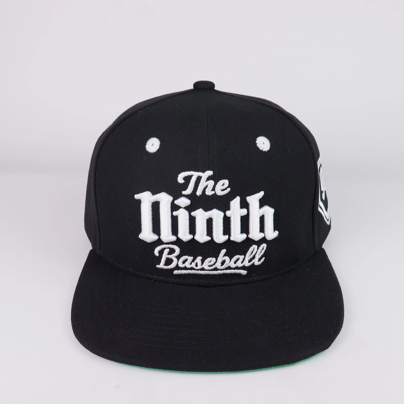 Front view of a black flat-brim cap with white embroidered lettering