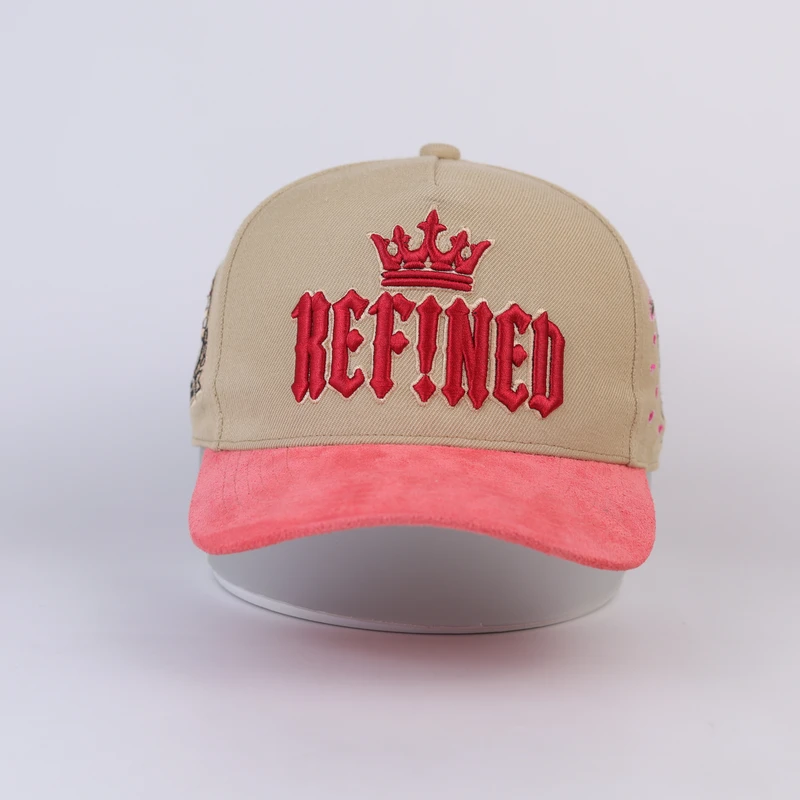 Front of khaki cap with raised red lettering and pink curved visor